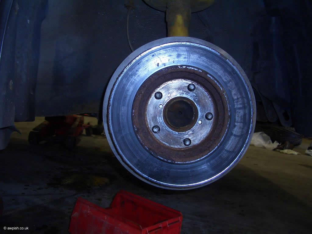 old disc lined up on wheel studs against new one